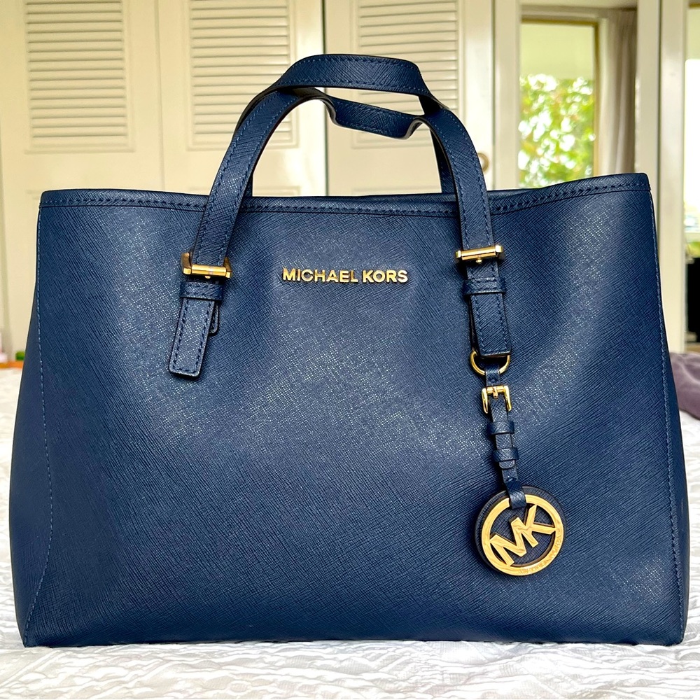 Micheal Kors Navy leather look Handbag with shoulder strap. 12”x 8.5”